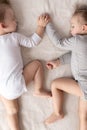 Childhood, sleep, relaxation, family, lifestyle, sweet dreams concept - two young children 2 and 3 years old dressed in Royalty Free Stock Photo