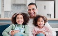 Childhood is such a precious time to cherish. Portrait of a father bonding with his two little daughters at home. Royalty Free Stock Photo