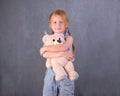 Childhood, toys and shopping concept. cute little girl hugging teddy bear Royalty Free Stock Photo