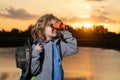 Childhood. Young boy looking through binoculars. Explore and adventure. Child boy with backpacks exploring nature and Royalty Free Stock Photo