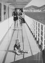 Childish loneliness. Family travelling on cruise ship, defocused. Family rest concept. Father, mother walk on deck of Royalty Free Stock Photo