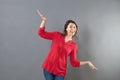 Childish woman using arms and hands like bird to fly like airplane