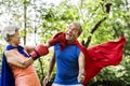 Childlike seniors wearing superhero costumes