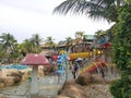 Children and adult tourists enjoying leisure activities having fun playing around resort water park Royalty Free Stock Photo