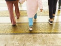 Children and adults cross the road on a pedestrian crossing on a cool day. Royalty Free Stock Photo