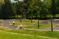 Children and adults ride bicycles and scooters on a special sports track. Sports activity concept Royalty Free Stock Photo