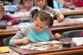 Children aged 6-9 years attend free drawing workshop during the open day in watercolors school