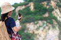 Children asian girl holding maps and Magnetic compass travel backpacks standing in the mountain