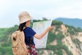 Children asian girl holding maps and Magnetic compass travel backpacks standing in the mountain