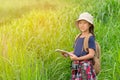 Children asian girl holding maps and travel backpacks walking in the green forest.