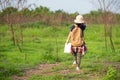 Children asian girl walking and holding maps and travel backpacks in the forest for education nature.