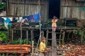 Children of asmat tribe near home in small deaf village in jungle of New Guinea Island.