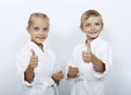 Children athletes with belts show thumb super Royalty Free Stock Photo