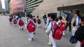 Shenzhen, China: children athletes walk past the sports square to take part in a competition