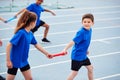 Children In Athletics Team Competing In Relay Race On Sports Day