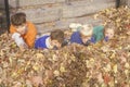 Children in autumn leaves aiming toy guns, Westpoint, NY