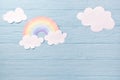 Children or baby background, white clouds with rainbow on the blue wooden background Royalty Free Stock Photo