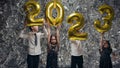 Children On Background Of Silver Scenery. Celebration. Children Lift Numbers Up.