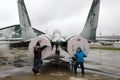 Children on background of Soviet multirole fighter Fulcrum