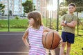 Children with a ball on an open basketball court. Healthy lifestyle and sport concepts Royalty Free Stock Photo