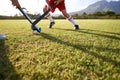 Children, ball and playing hockey on field for game, sports or outdoor match together. Team, kids or players in Royalty Free Stock Photo