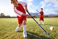 Children, ball and playing hockey on green grass for game, sports or outdoor match together. Team, kids or players Royalty Free Stock Photo
