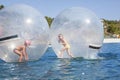 Children in a balloon floating on water.