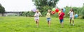 Children with balloons run in the summer park Royalty Free Stock Photo