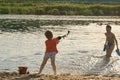 Children bathe in the evening on the city beach Royalty Free Stock Photo