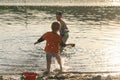 Children bathe in the evening on the city beach Royalty Free Stock Photo