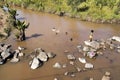 Children bathe in the muddy river, Madagascar