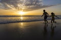 Children bathing on the beach at dusk Royalty Free Stock Photo