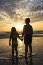 Children bathing on the beach at dusk Royalty Free Stock Photo