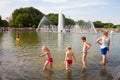 Children bathing in fountain pond