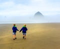 Children on Beach. Backs to Camera. Cannon Beach.