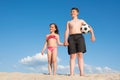 Children on the beach play with a ball. Holidays, rest. Sports and active lifestyle concept