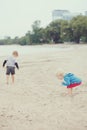 Children on beach playing picking seashells