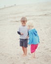 Children on beach playing picking seashells Royalty Free Stock Photo