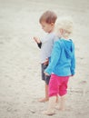 Children on beach playing picking seashells Royalty Free Stock Photo