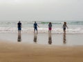 Children at beach with Reflections in Wet Sand Royalty Free Stock Photo