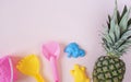 Children beach toys and pineapple on pastel pink background. Summer concept. Flat lay, top view, copy space. Kids summer Royalty Free Stock Photo