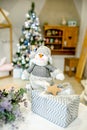 Children bedroom decorated for Christmas. Toy snowman and gift box on the background of the Christmas tree lights and bed. Royalty Free Stock Photo