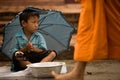 Children begging during the procession of local monks