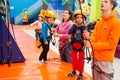 Children being equipped for climbing an artificial wall