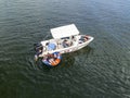 Children being picked up by boat after being towed on a tube at local dam