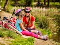 Children bicycle have rest near water in park outdoor. Royalty Free Stock Photo