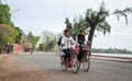 Children biking on street in Kampot, Cambodia