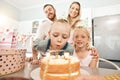 Children birthday party, cake and candles for blowing out with mother, father or sister in home kitchen. Fun, excited or Royalty Free Stock Photo