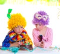 Children birthday party clown wigs blowing cake candles Royalty Free Stock Photo