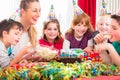 Children on birthday party nibbling candies